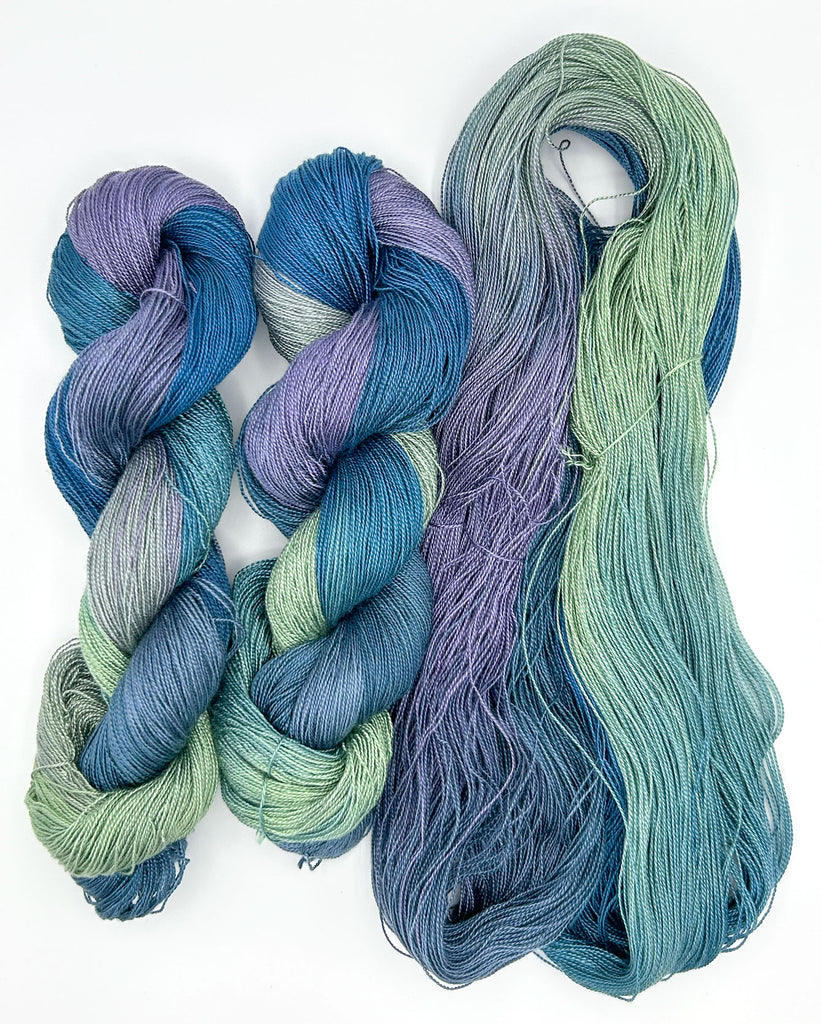 Small Batch 52 5/2 Tencel Hand-Painted Yarn: Three skeins of blue and green yarn on a white background