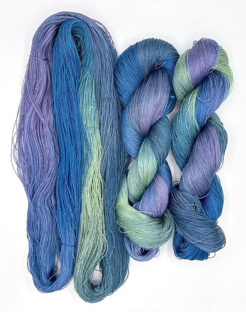 Small Batch 53 8/2 Tencel Hand-Painted Yarn: Three skeins of blue and green yarn on a white background